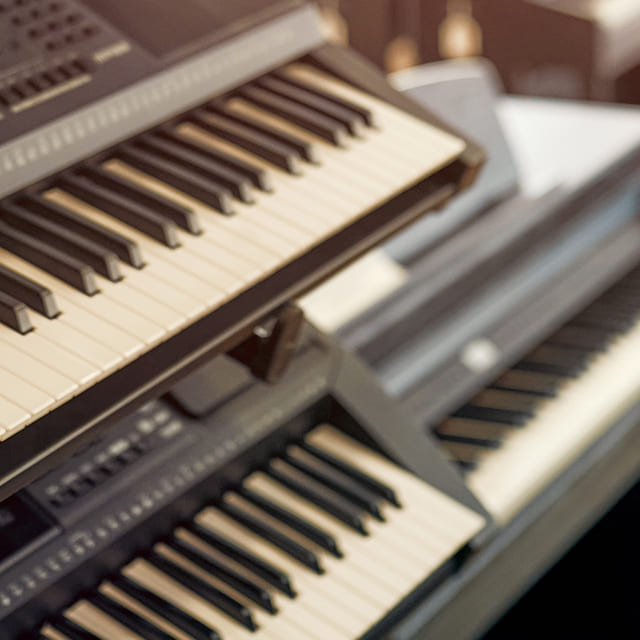 Background image of digital pianos in a music store